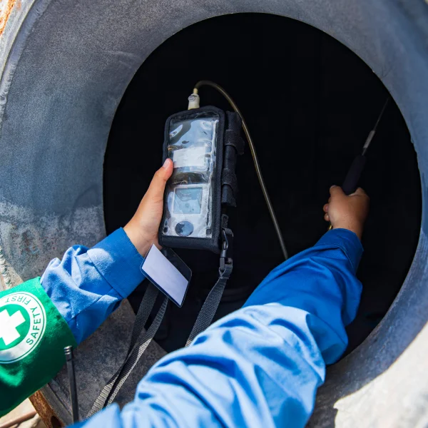 Une personne tenant un appareil pour l'entretien d'un système septique.